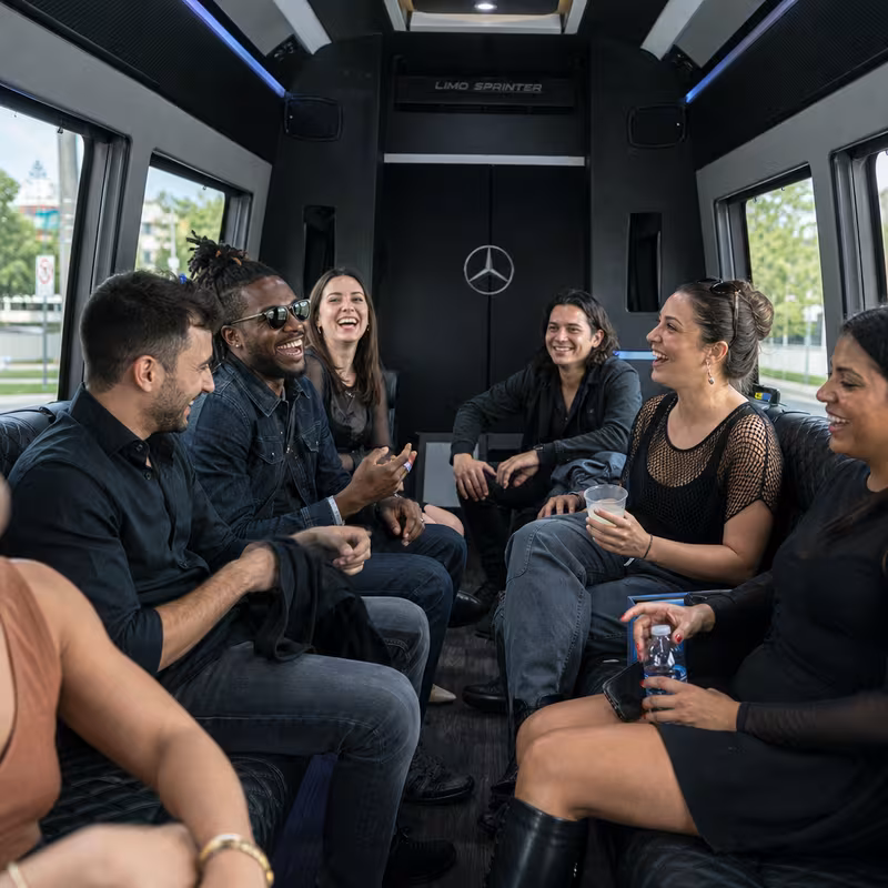 Group boarding a white charter bus for Concert Transportation transportation in St. Petersburg