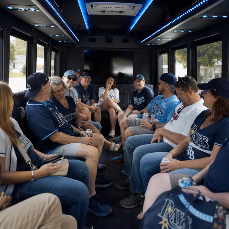 Group boarding a white charter bus for Sporting Event Transportation transportation in St. Petersburg